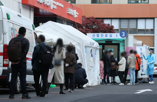 11일 오전 서울 중구 국립중앙의료원 선별진료소에서 시민들이 코로나19 검사를 받기 위해 줄을 서 있다. [연합뉴스]